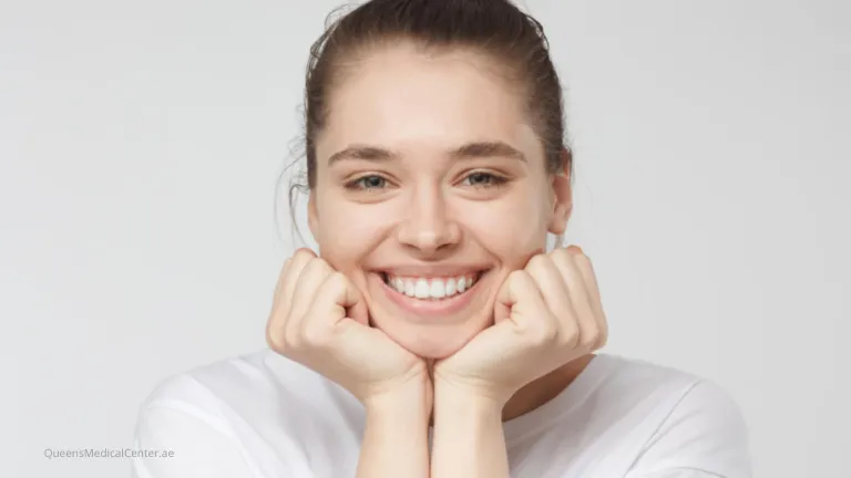 A cheerful young woman smiling brightly outdoors, representing the benefits of smiling more often.